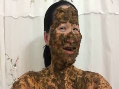An Asian woman with scat eyes chuckles.